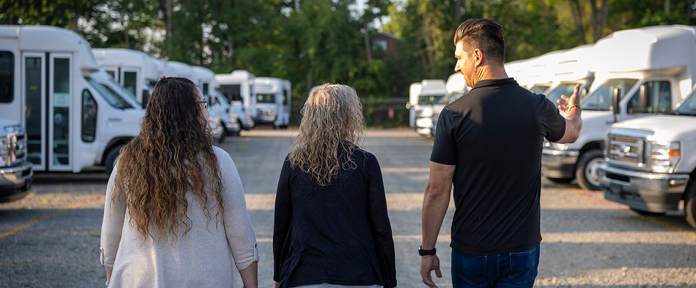customers looking at a fleet of new vehicles